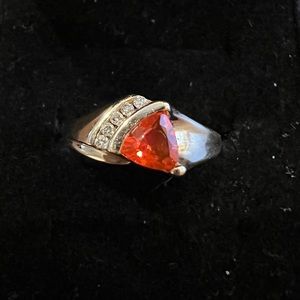 Orange garnet (untested) with five accent stones. Set in 14k gold. Size 10